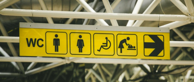yellow public toilets sign