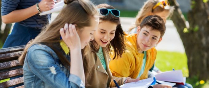 students sat on bench at school