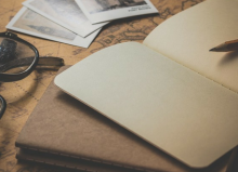 old fashioned photo of notepad pencil and pair of glasses