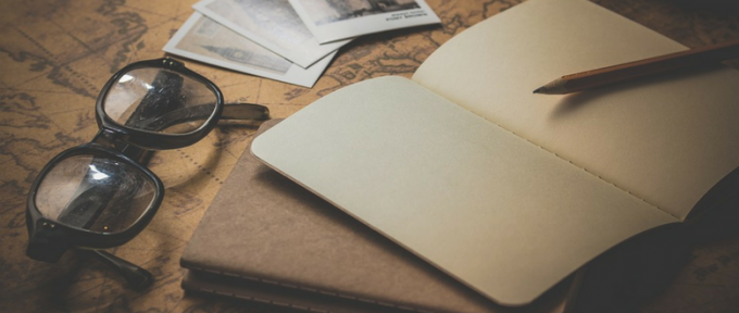 old fashioned photo of notepad pencil and pair of glasses