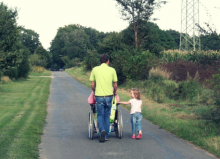 dad with wheelchair user daughter and other daughter