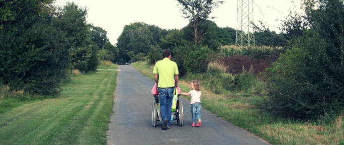 dad with wheelchair user daughter and other daughter