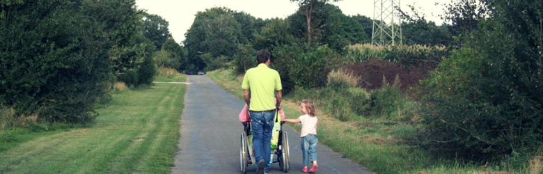 dad with wheelchair user daughter and other daughter