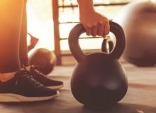 hands lifting dumbells at the gym