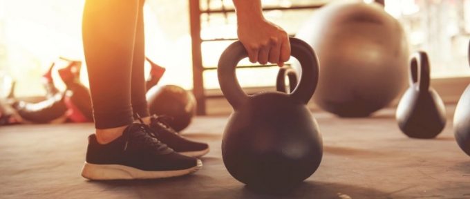 hands lifting dumbells at the gym