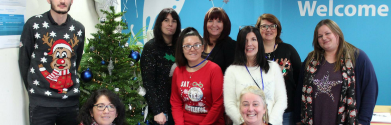 disabled living team photo wearing christmas jumpers