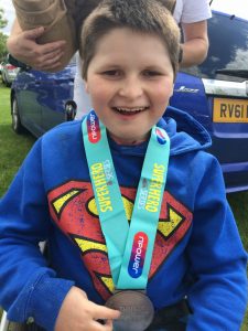 Sebastian with triathlon medal