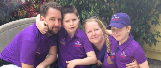 sebastian with his mum dad and brother wearing purple polo tshirts