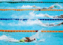 4 swimmers in lanes for swimming race