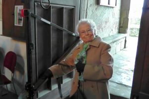 Church steps hand rail being used by elderly lady