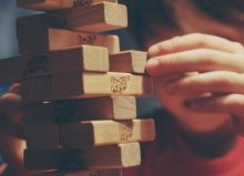 little boy playing jenga