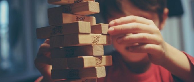 little boy playing jenga