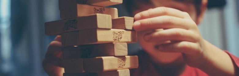 little boy playing jenga