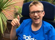 ben - young boy with cerebral palsy sat in his garden