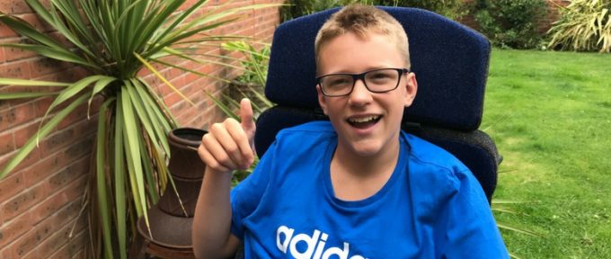 ben - young boy with cerebral palsy sat in his garden