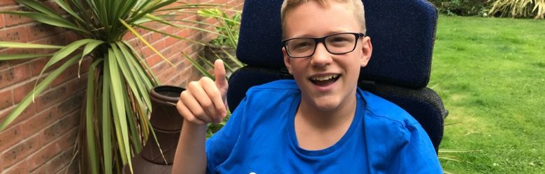 ben - young boy with cerebral palsy sat in his garden