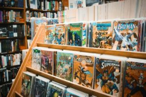 assorted comic books on brown wooden shelf