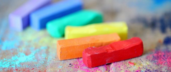 assorted coloured chalks on wood surface
