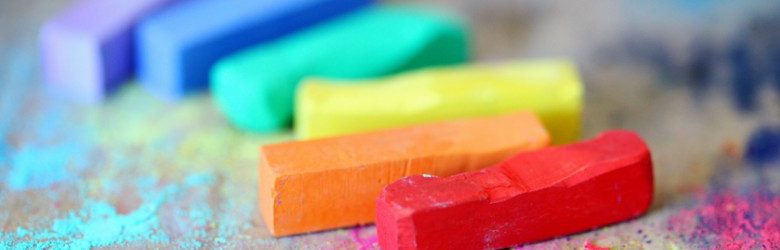 assorted coloured chalks on wood surface