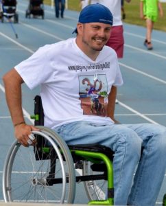 portrait of David smiling in his wheelchair