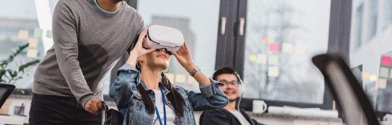 woman in wheelchair using virtual reality glasses at modern office