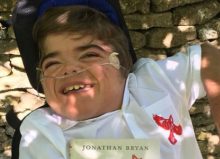 jonathan in his wheelchair with his book