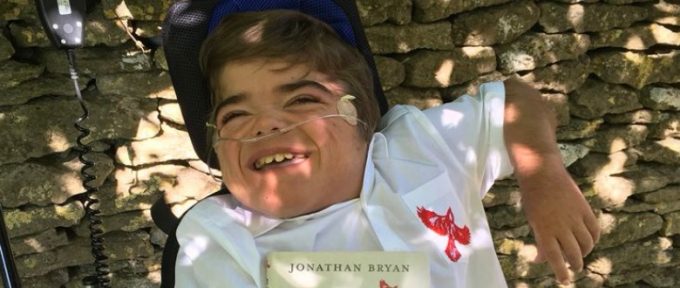 jonathan in his wheelchair with his book