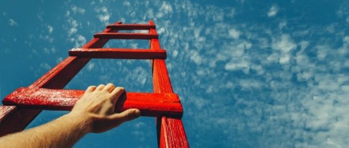 hand reaching out for ladder towards blue sky