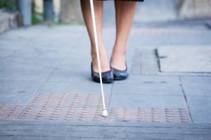 blind woman using a white cane