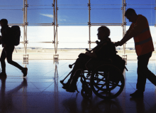 accessible travel - silhouette of man in wheelchair at airport