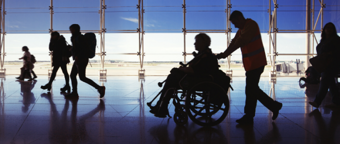 accessible travel - silhouette of man in wheelchair at airport