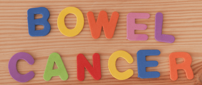 bowel cancer letters on wooden background