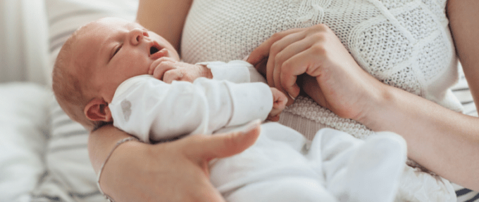 newborn baby being held