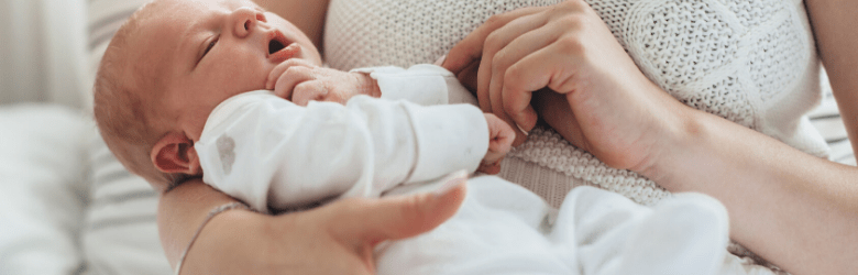 newborn baby being held