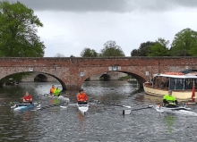 members of the rowing group by the bridge