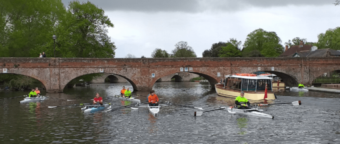 members of the rowing group by the bridge