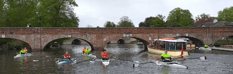 members of the rowing group by the bridge
