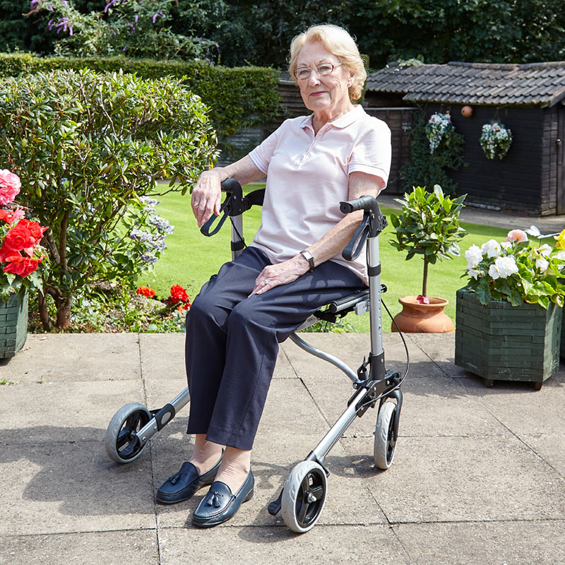 woman sat in her wheelchair in the garden