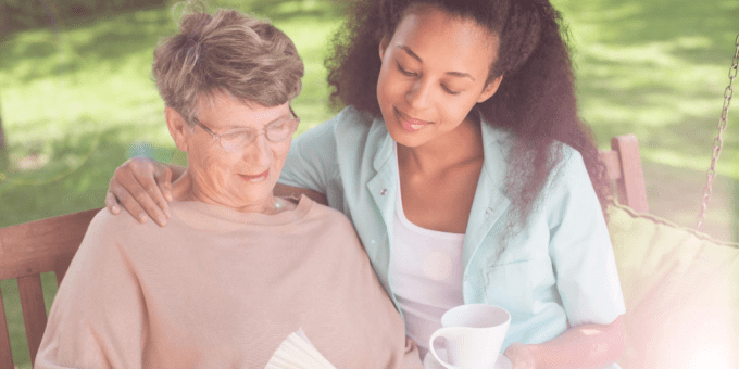 person reading with carer outside