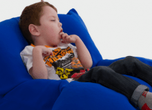 Child on AAT GB posture cushion