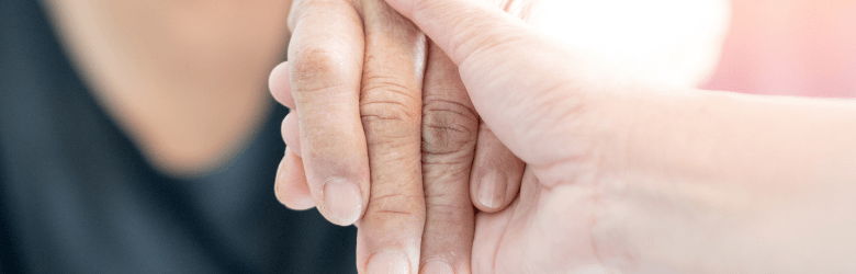 Old woman holding hand